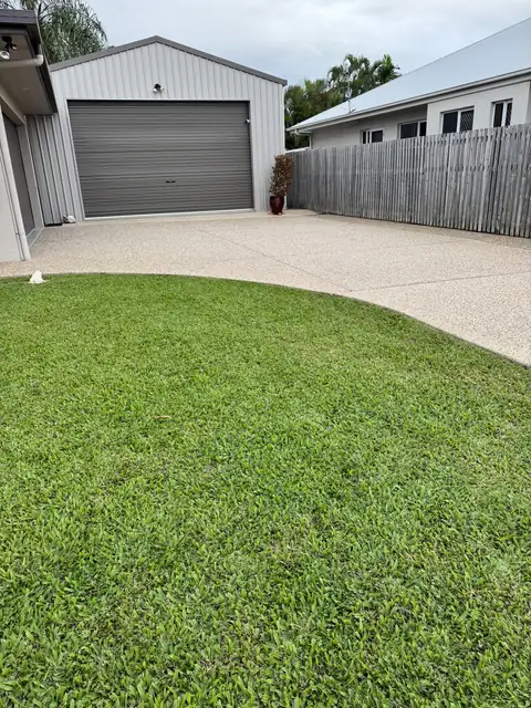 An exposed aggregate driveway after sealing, with a fresh wet look