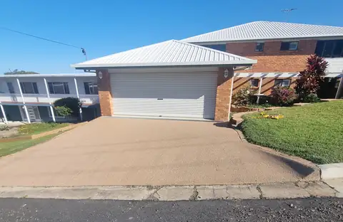 A driveway sealed in an even sandy brown colour
