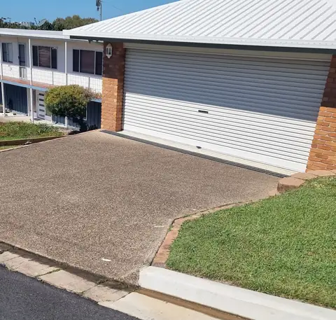 Before: a worn, patchy grey driveway