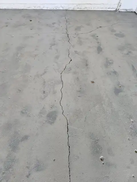 Before: a long crack running across a bare concrete garage floor