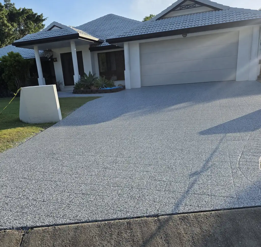 After: the same driveway sealed in an even grey speckled finish