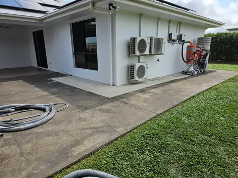 A patio mid job with hoses and cleaning gear set out
